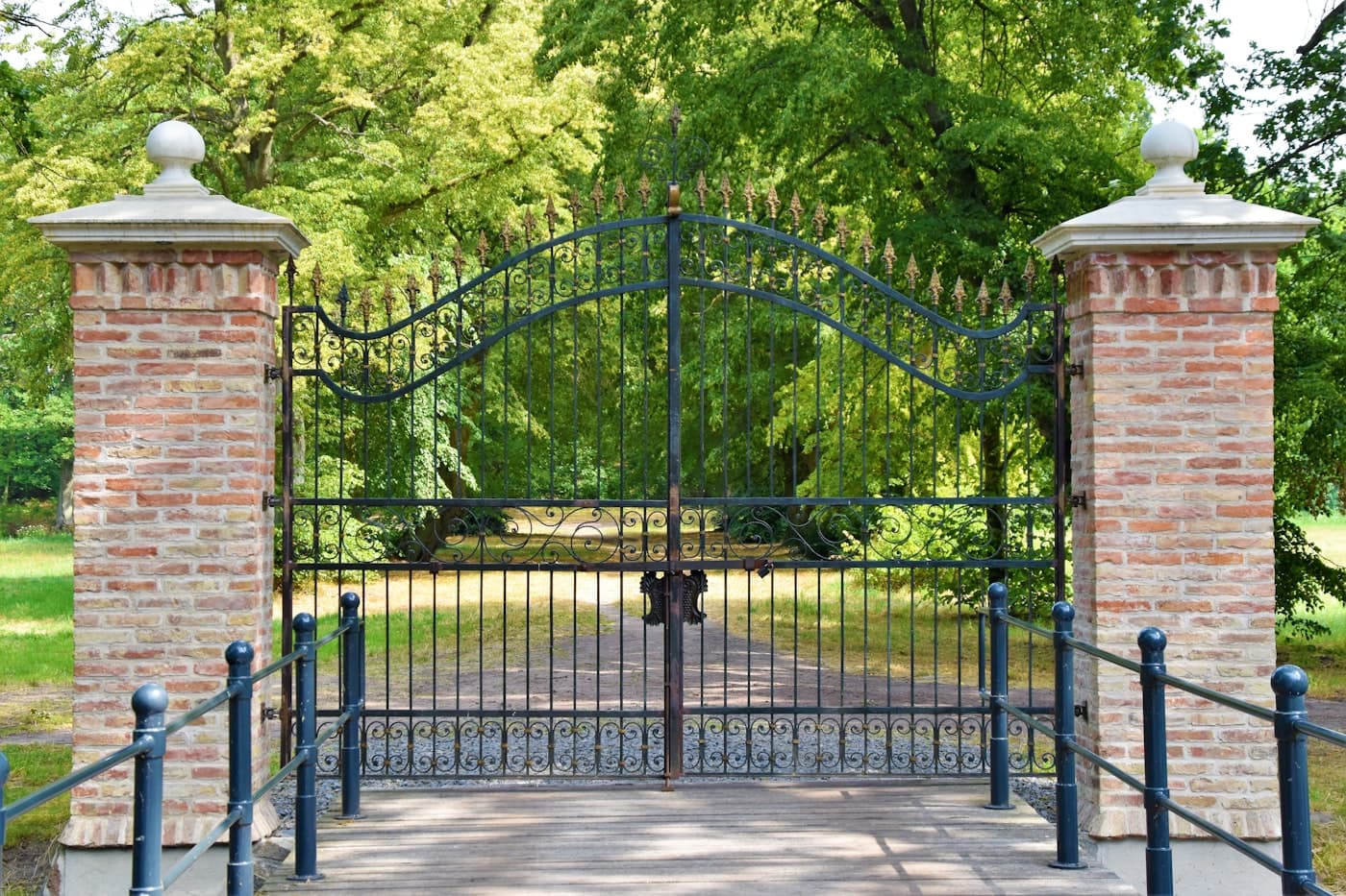 Motorised automatic entrance gate with ornamental ironwork at residential estate