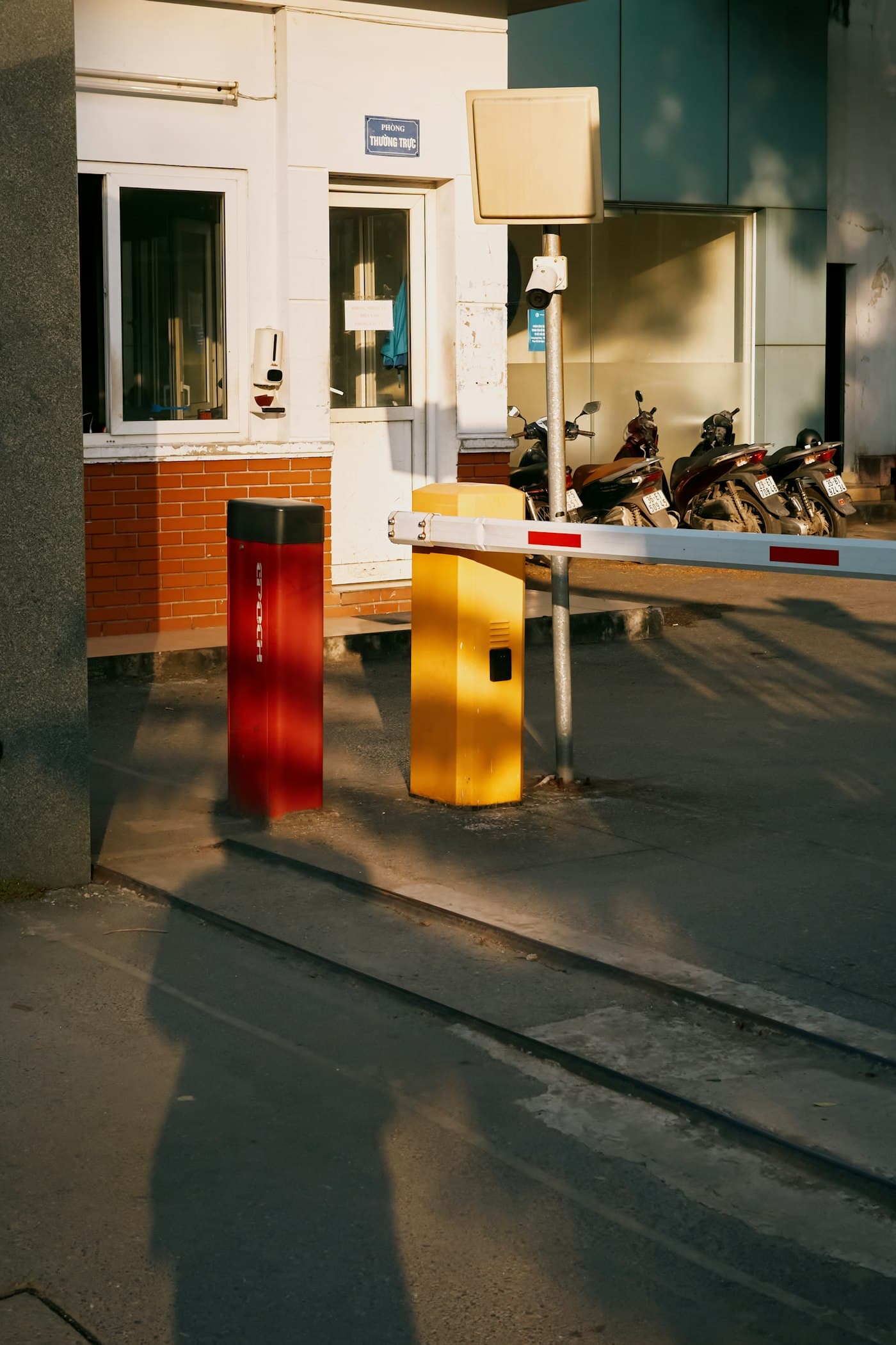 Folding arm boom barrier at covered car park entry