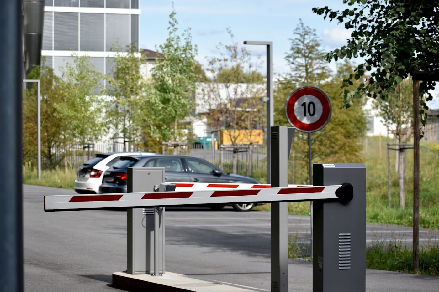 Swing arm boom barrier at industrial site entry